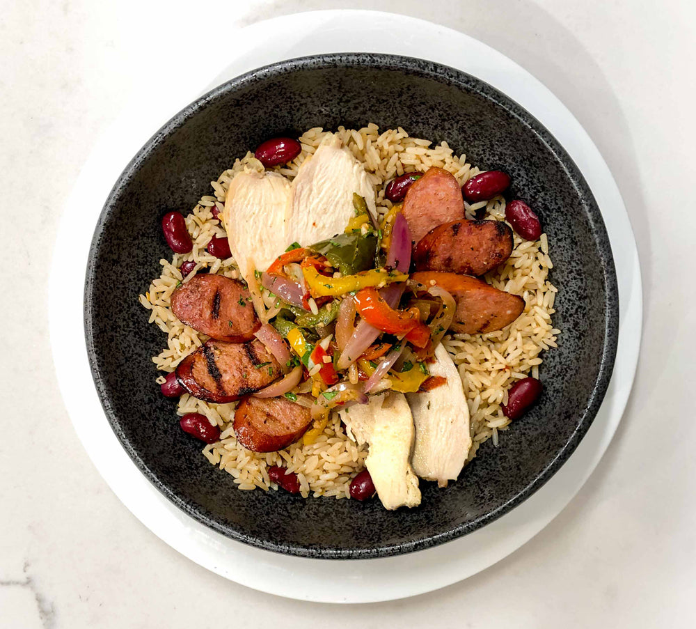 Deep flavors in this Jambalaya with sausage, chicken, vegetables on dirty rice and beans.